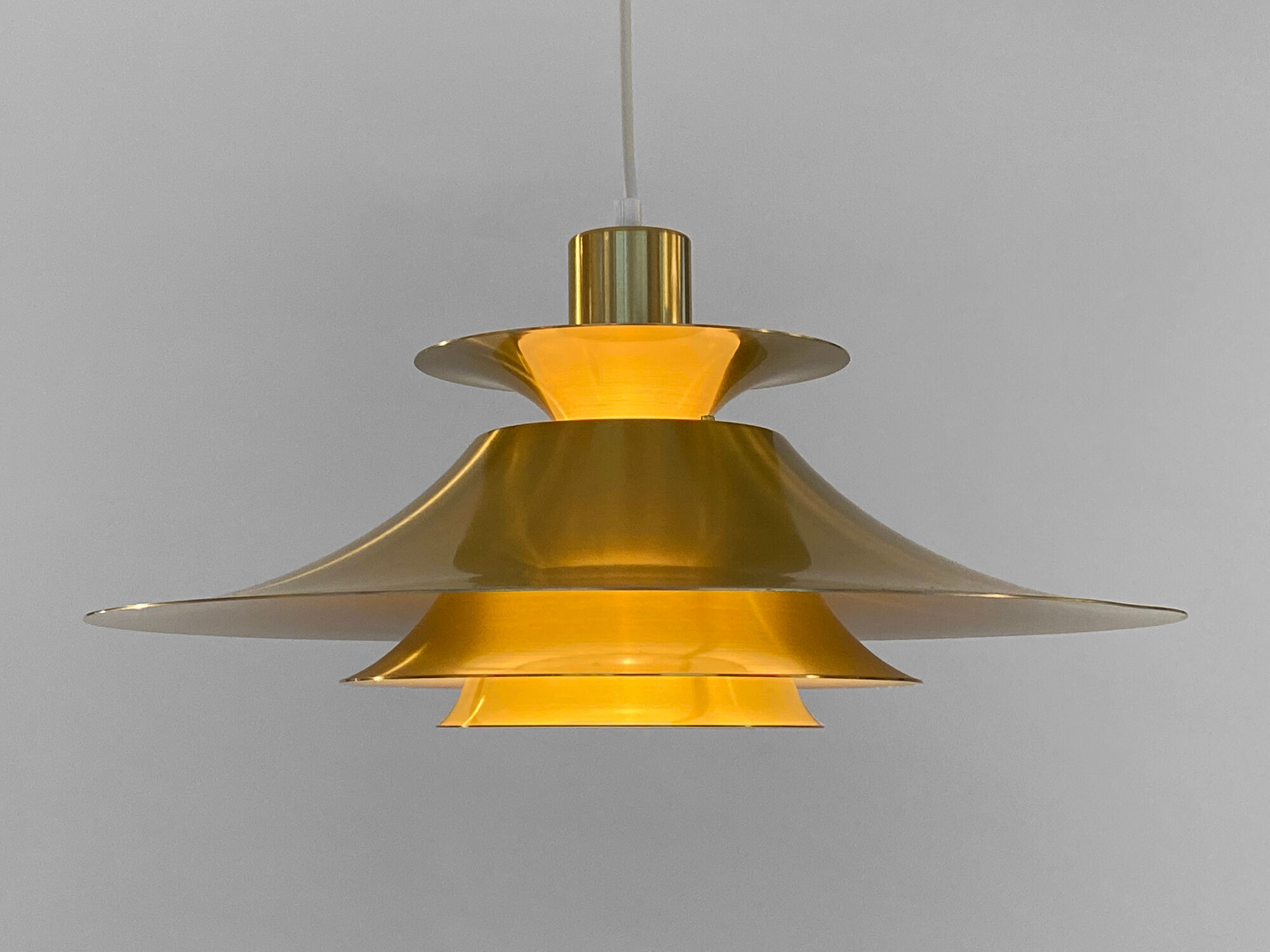 Golden colored aluminum pendant light from Frandsen Lighting. Denmark 1970s