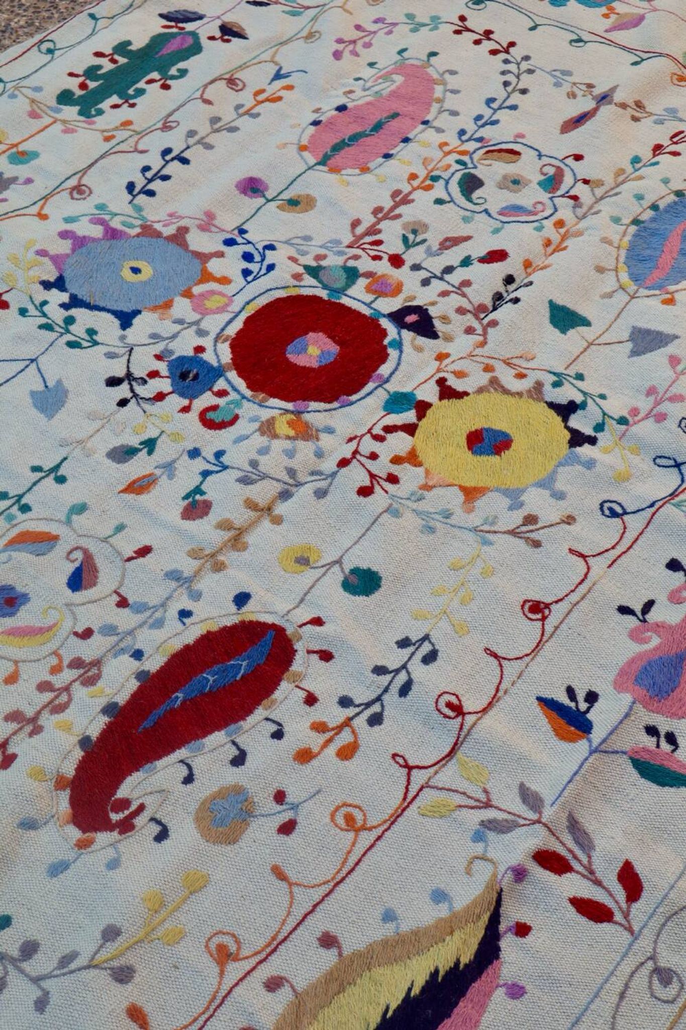White suzani kilim rug with hand embroidered multi-colored patterns