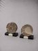 Vintage pair of bookends in fossilised coral agate | Stone disc-shaped bookends on a black marble base