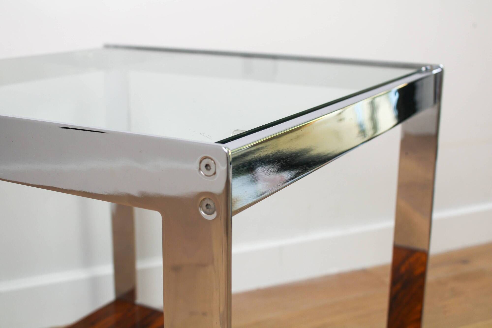 A vintage mid-century glass and rosewood side table by Merrow Associates