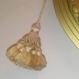 Oval mirror in wood and gilded plaster with pompom decoration