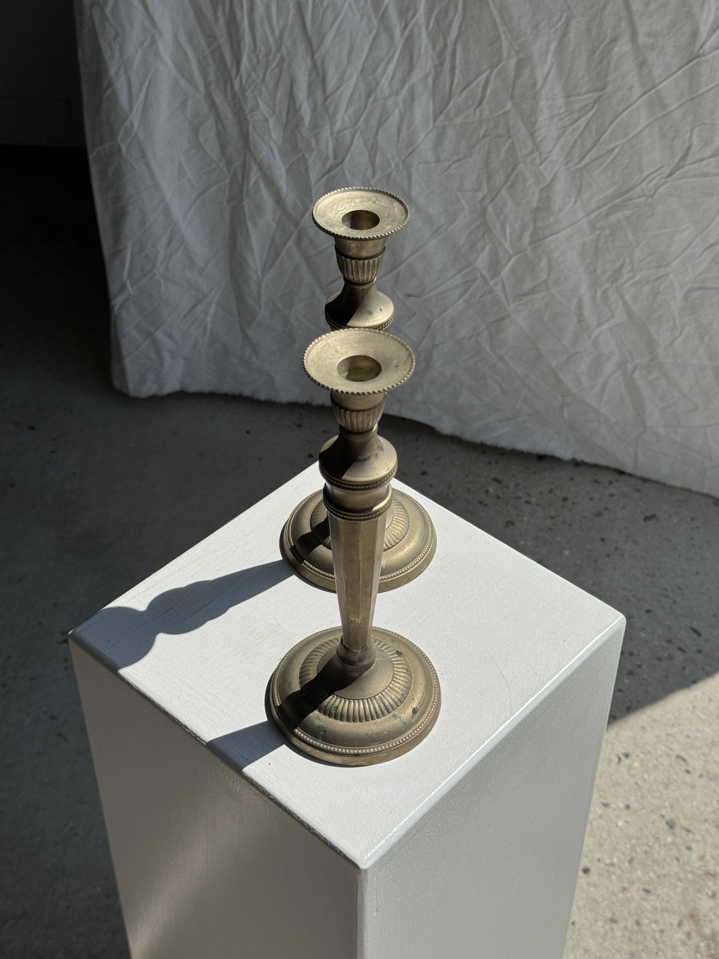 Pair of classic candlesticks in patinated gold metal H25