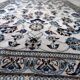 1950s hand-knotted wool rug with silk highlights, ivory and blue, 118 × 200 cm