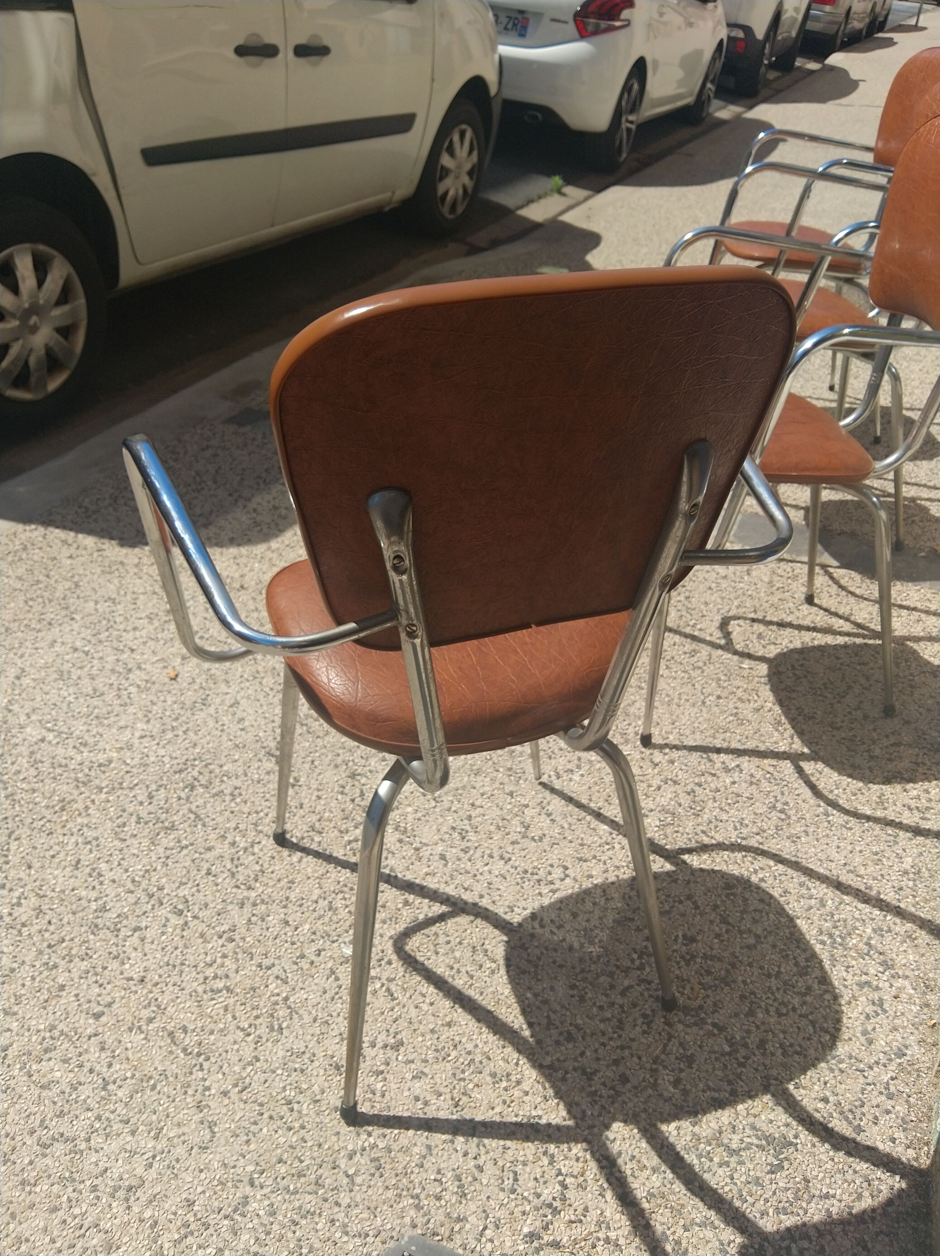 Set of 4 armchairs in chromed metal and brown imitation leather, circa 1960