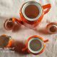 Iridescent orange porcelain coffee set from the 50s-60s with black edging