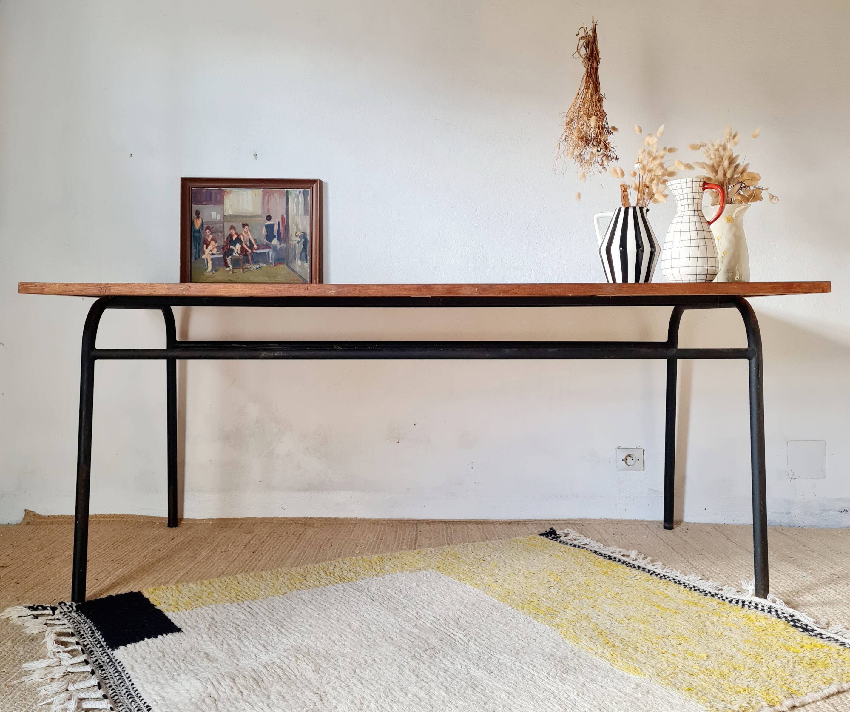Metal tubular base table with a wooden top.