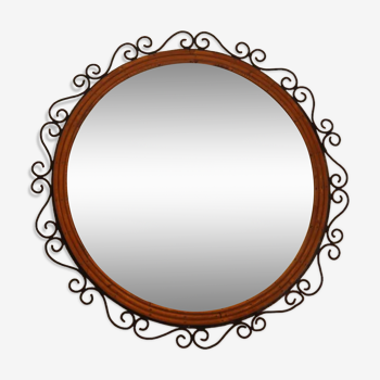 Round mirror in iron and rattan