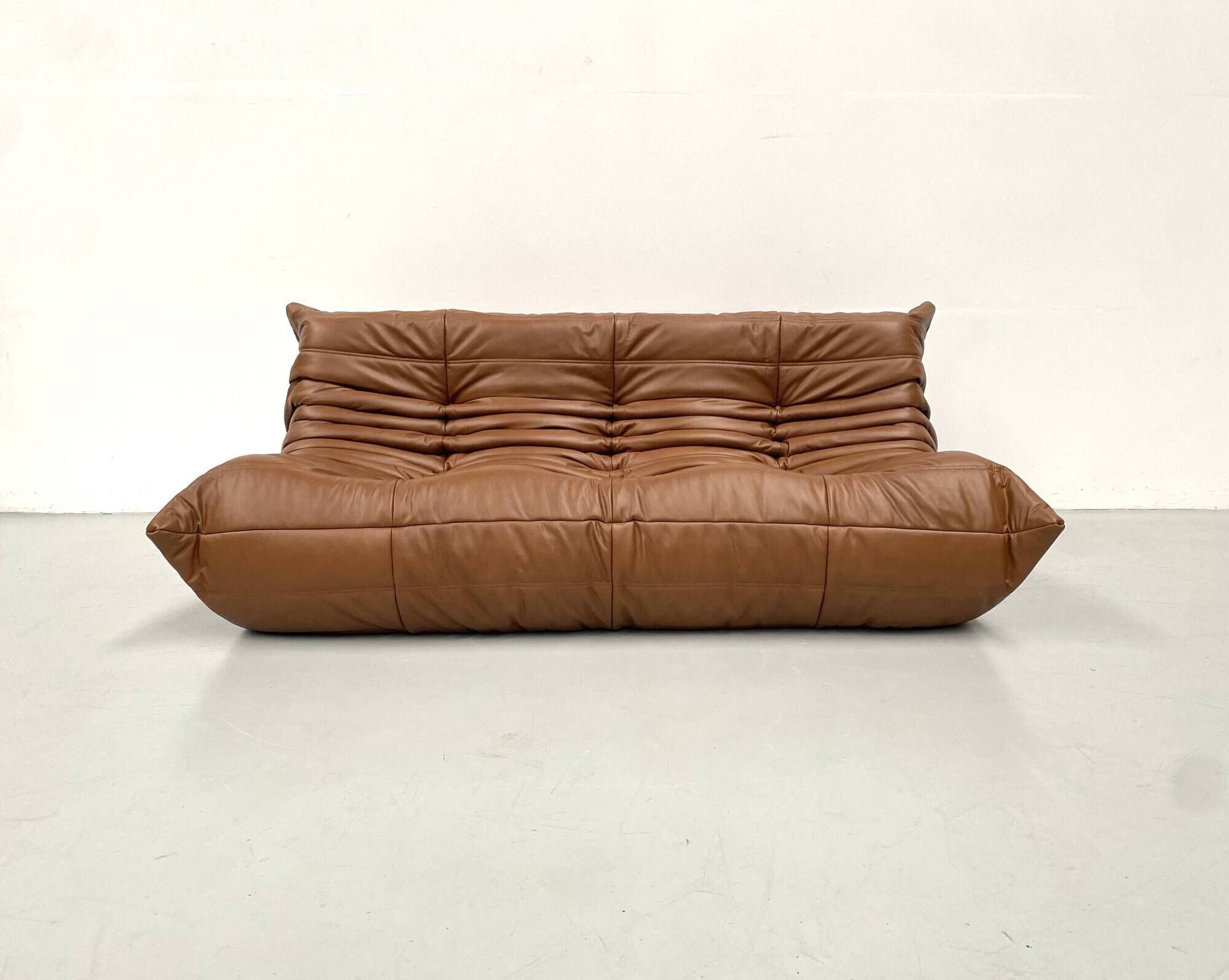 Togo 3-seater in Cognac leather designed by Michel Ducaroy for Ligne Roset.