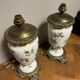 Old pair of porcelain oil lamps decorated circa 1900