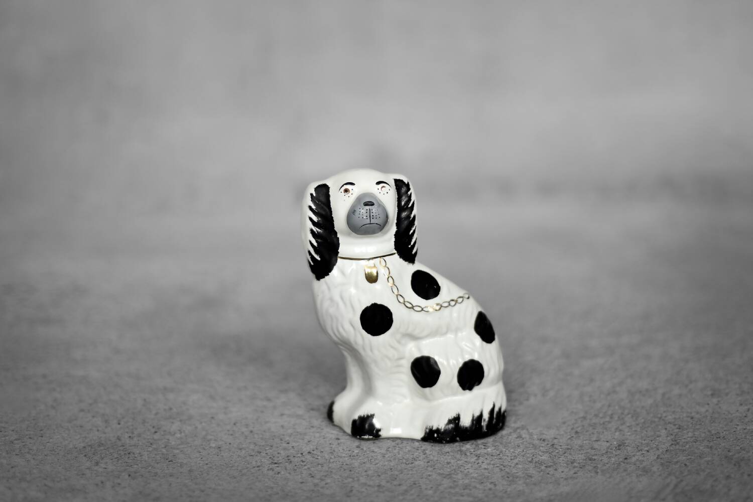 Vintage ceramic figurine from Staffordshire depicting a spaniel dog, England.