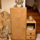 Asymmetrical cabinet made of raw wood