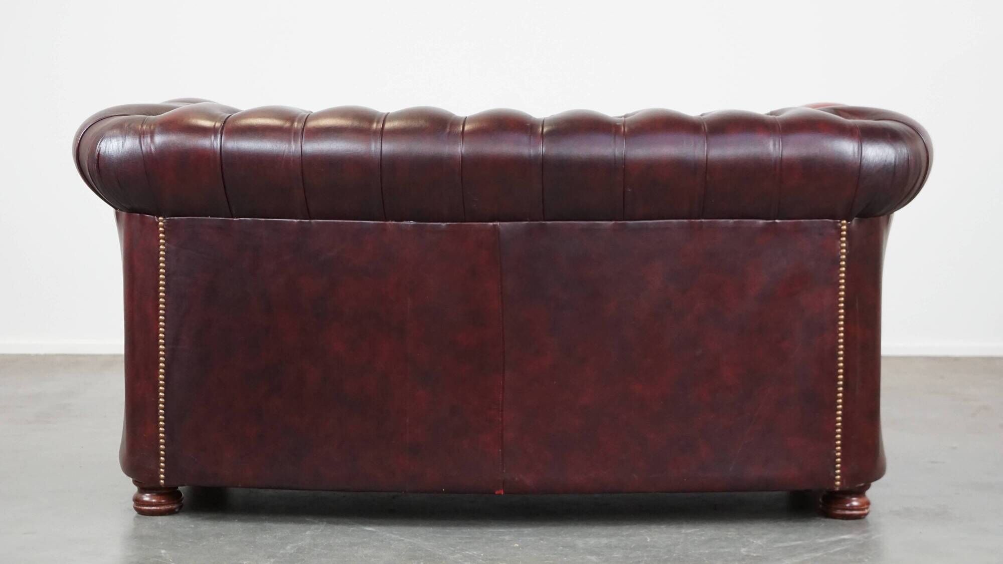 Original English Chesterfield sofa in red cowhide 2 seater