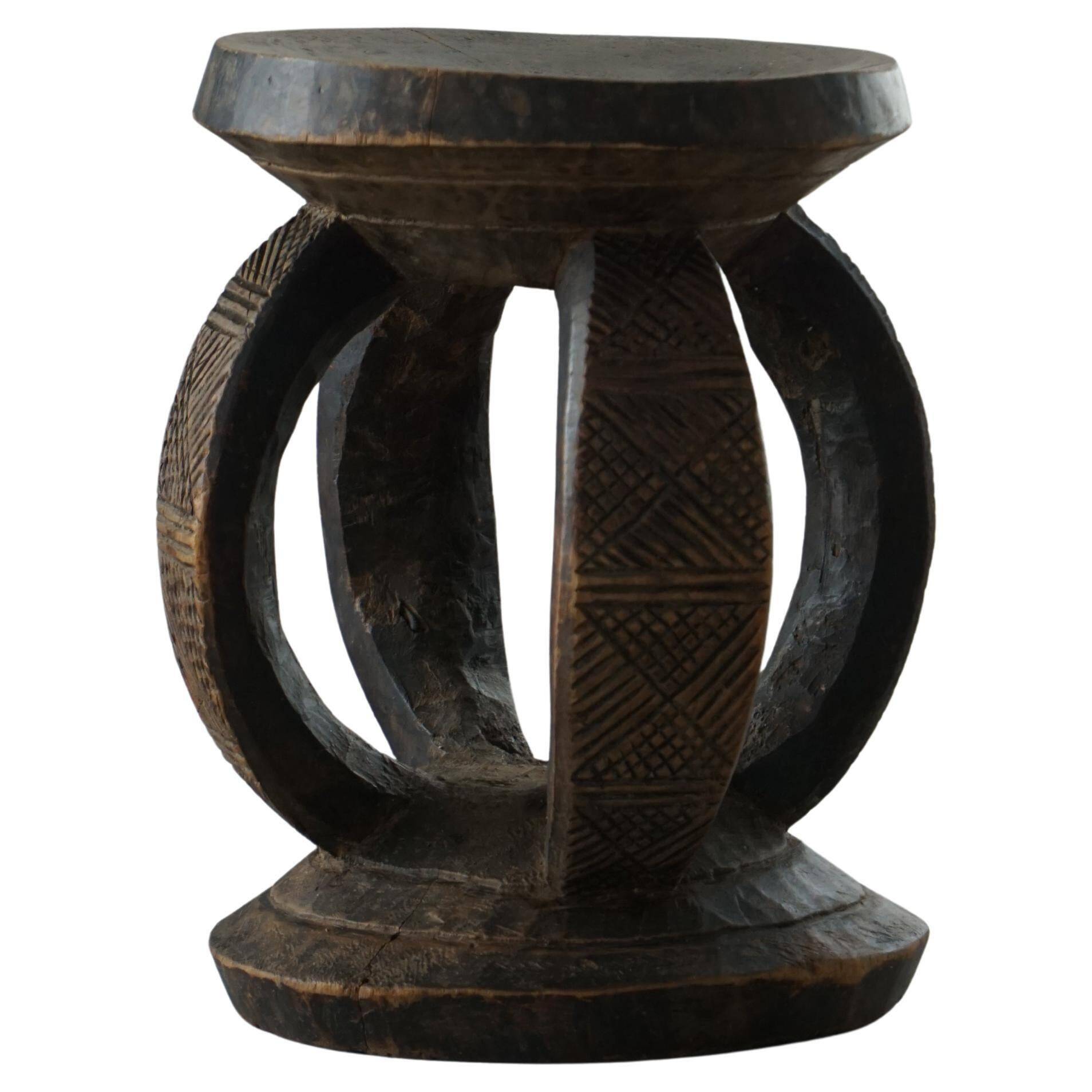 Antique wooden stool hand-carved by the Dogon people of Africa, Wabi-Sabi style, mid-20th century.