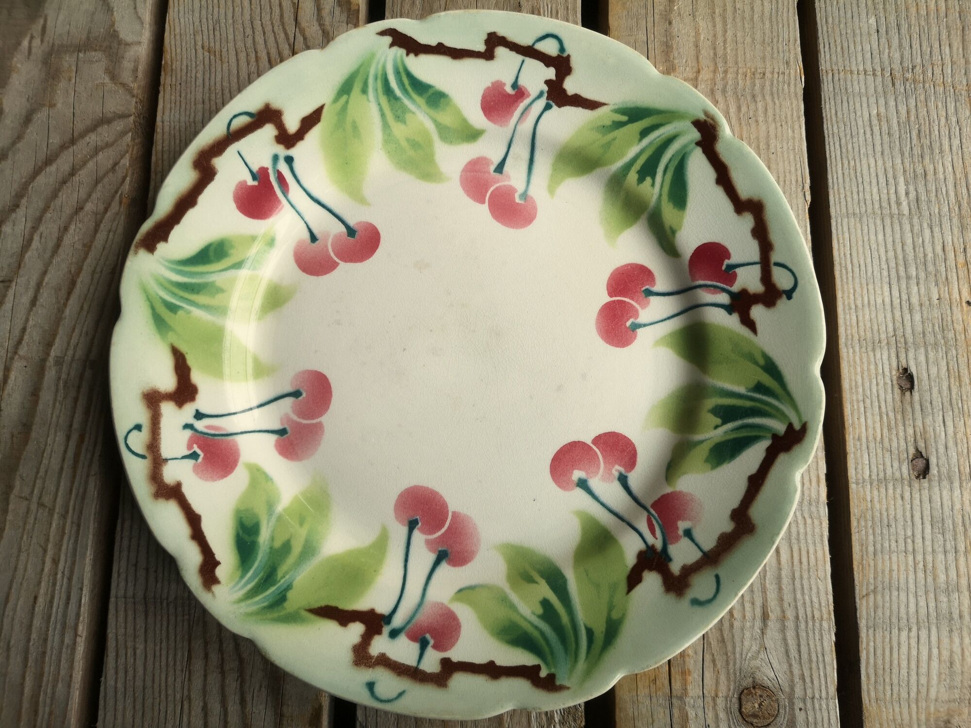 Old decorative plate in barbotine by luneville cherry motif