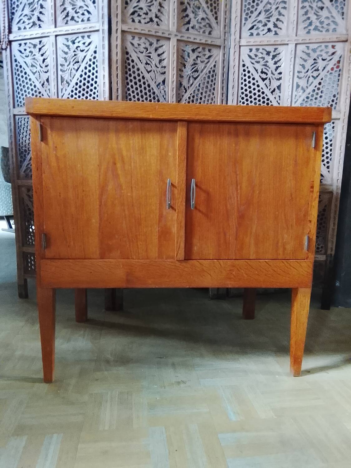 Vintage storage unit with two doors and four drawers.