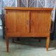 Vintage storage unit with two doors and four drawers.