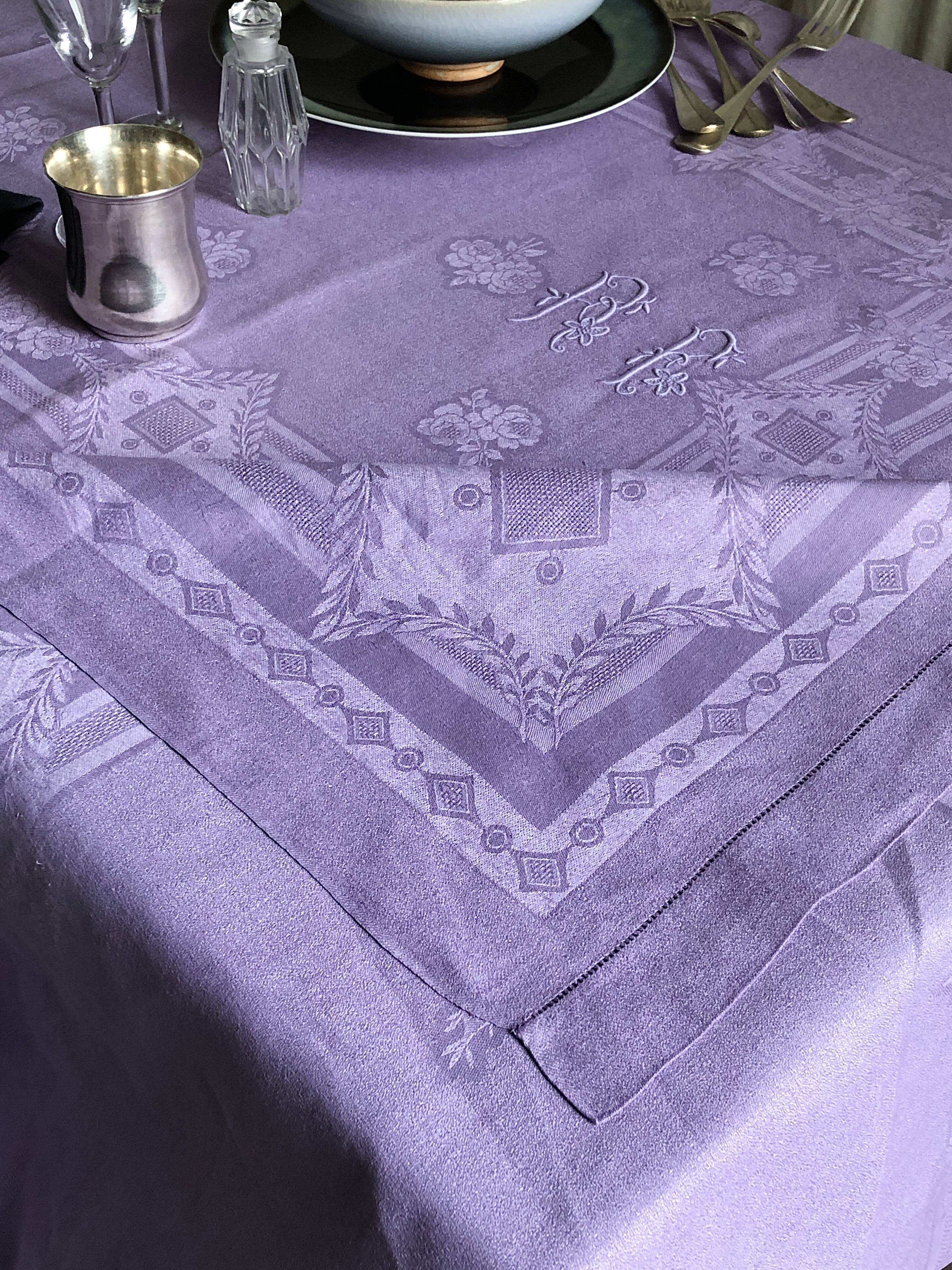 Old damask tablecloth in linen and purple silk