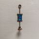 Wall-mounted candle holder in cast iron and hard pressed blue glass.