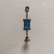 Wall-mounted candle holder in cast iron and hard pressed blue glass.