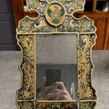 Eglomise glass mirror with scrollwork and branch races decoration