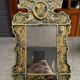 Eglomise glass mirror with scrollwork and branch races decoration