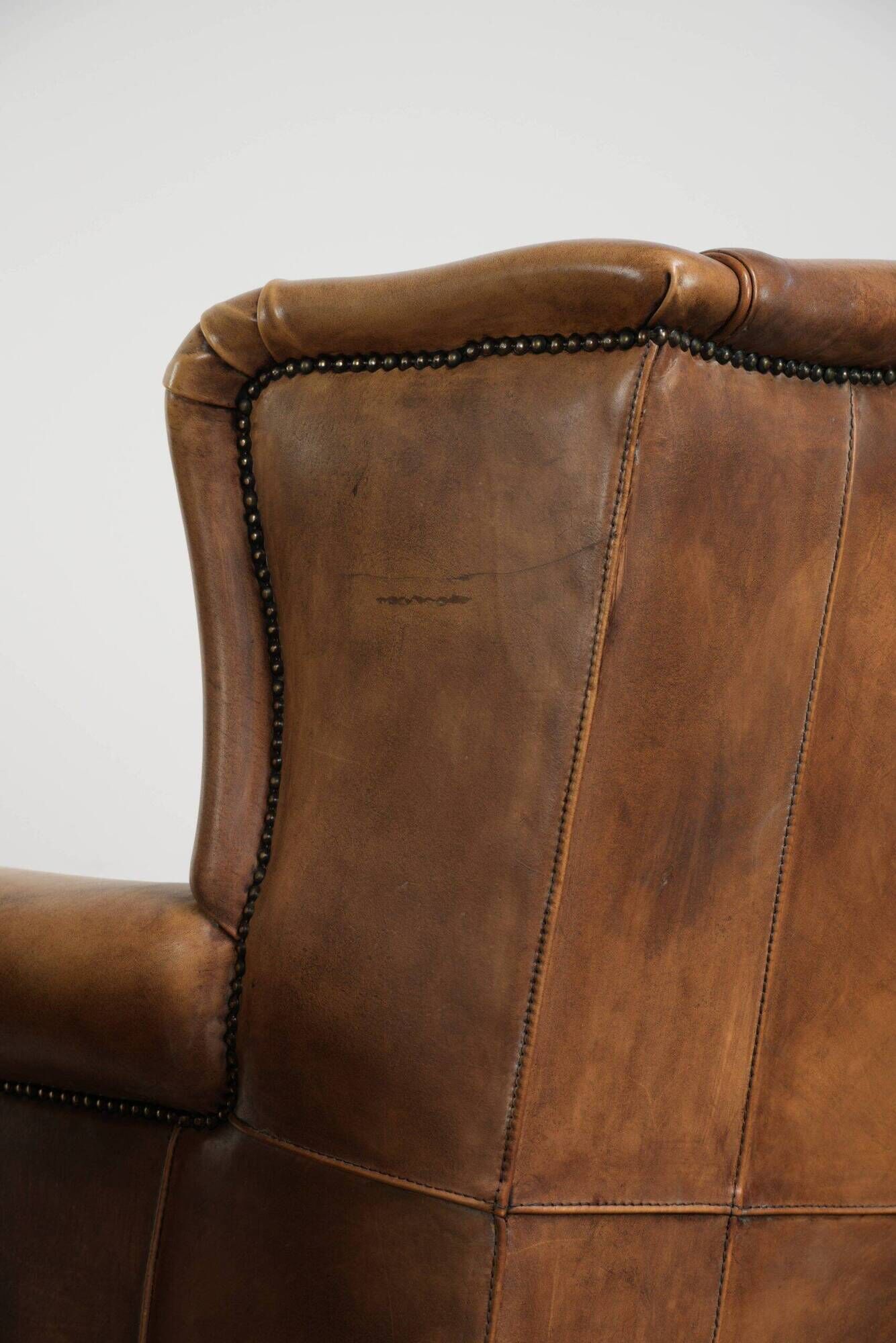 Set of two light cowhide wingback armchairs with a timeless English look