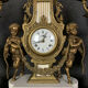 Pendule triptyque aux "Amours de Bacchus" en bronze a patine brune.