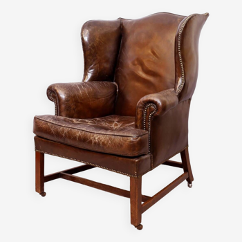 Wingback armchair in dark brown patinated leather, 1970s