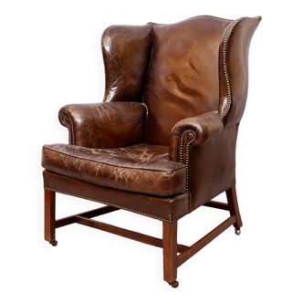 Wingback armchair in dark brown patinated leather, 1970s