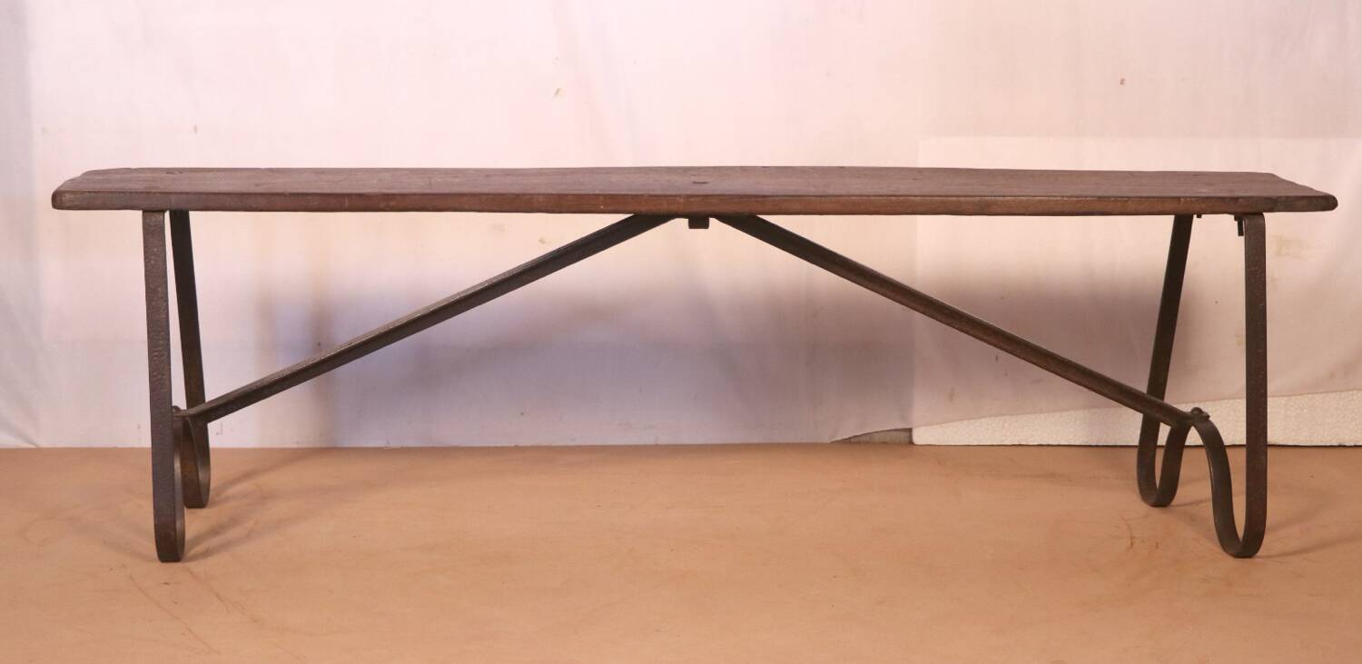 Old bench in Burmese teak with a wrought iron base.