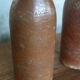 Set of 2 sandstone bottles with ceramic capsule