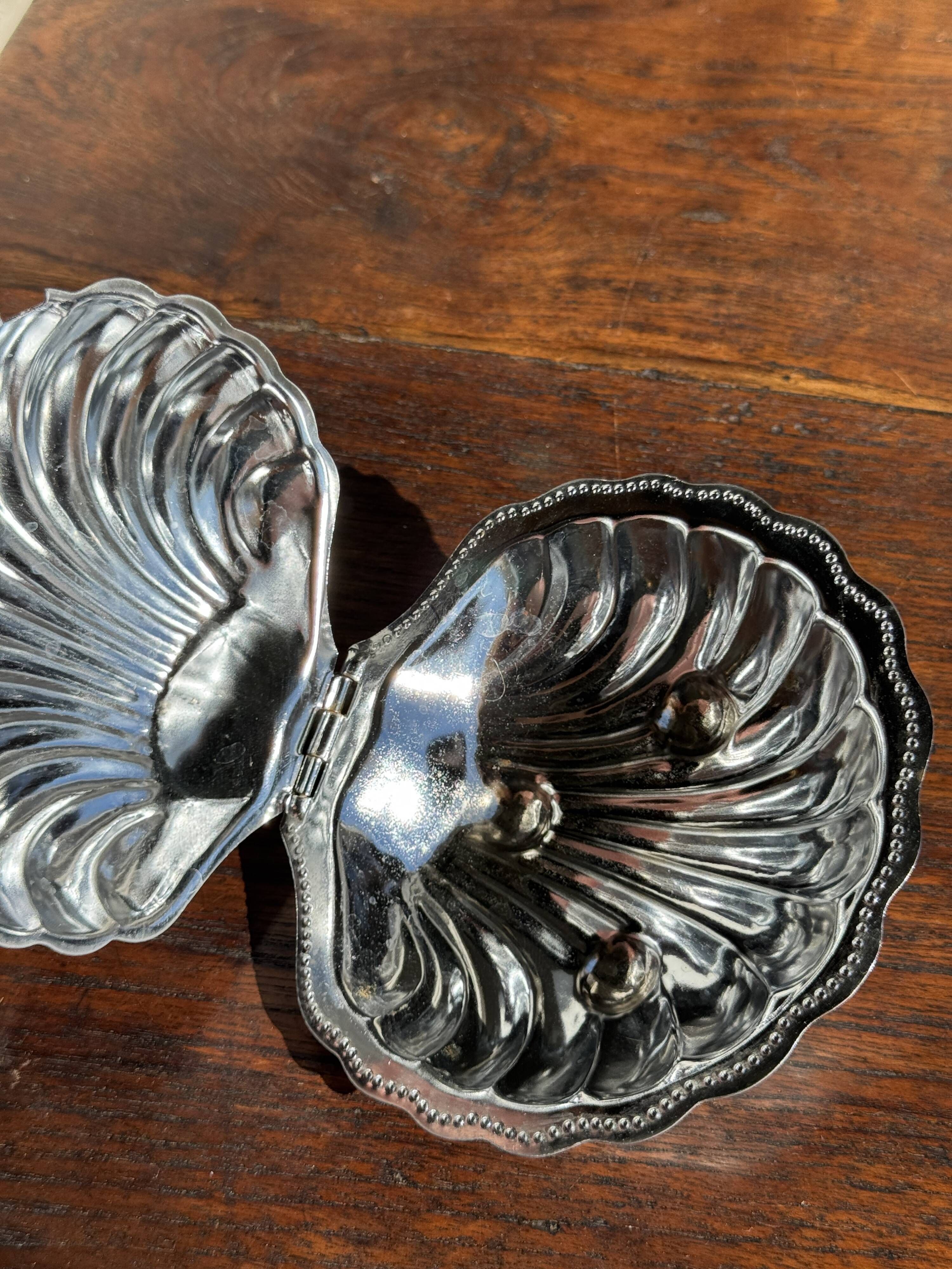 Vintage silver-plated shell butter dish with transparent bowl.