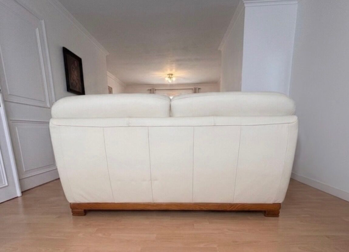 Beige leather sofa with solid wood frame