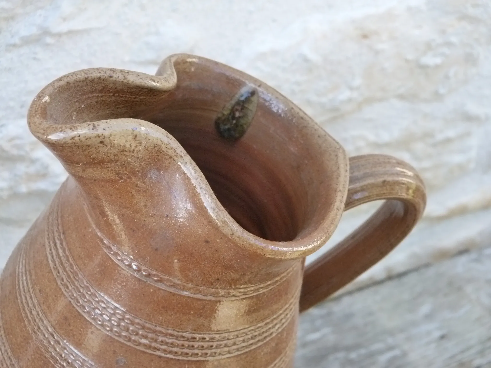 Old stoneware wine jug with patterns