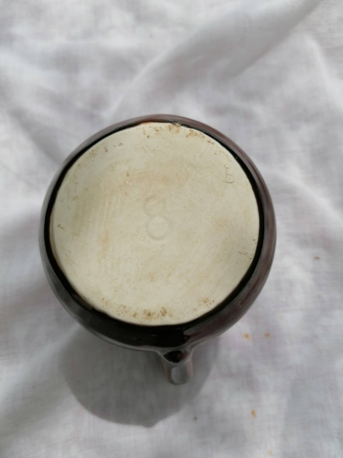 Brown ceramic teapot and milk jugs