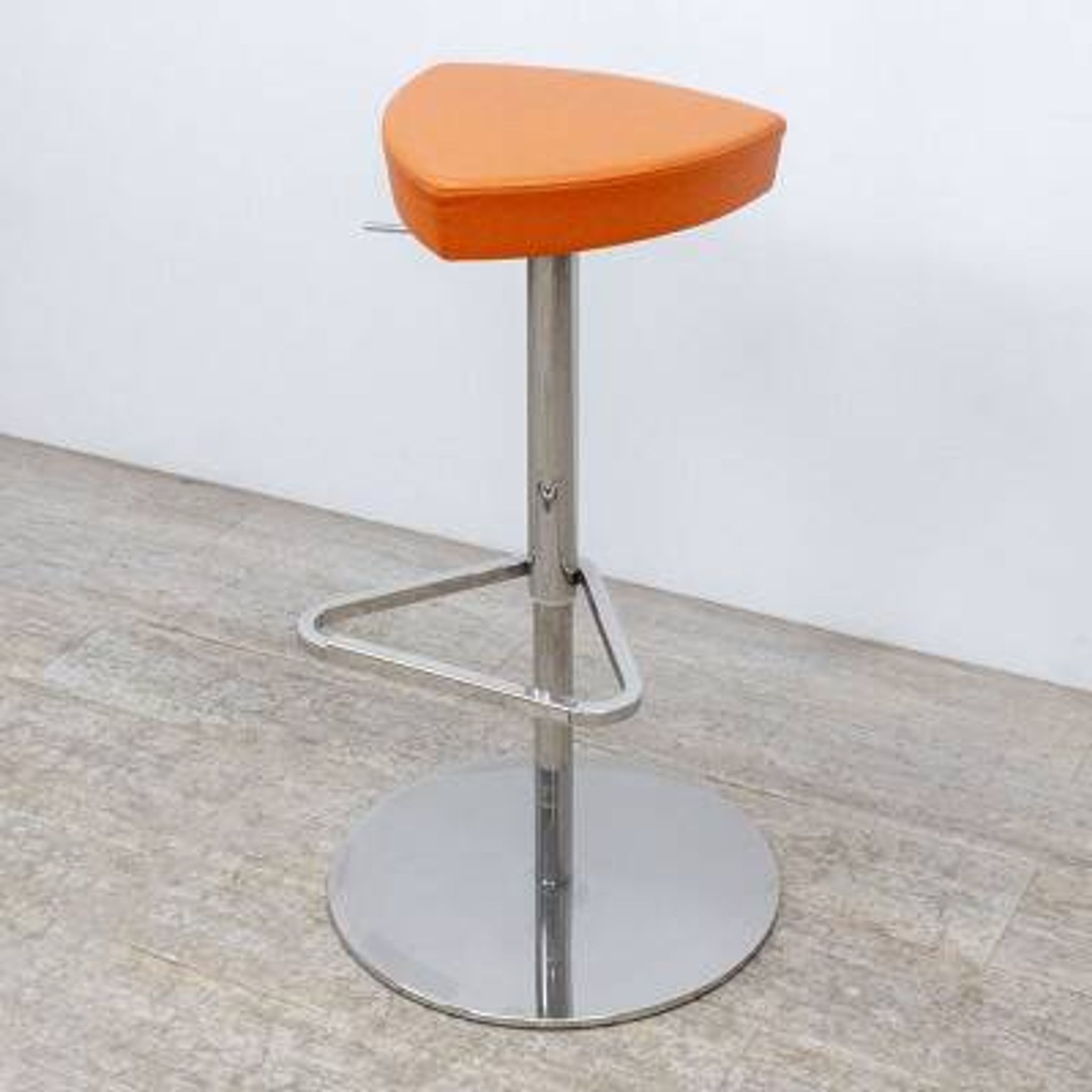 Adjustable orange swivel bar stool