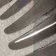 12 silver-plated metal table knives with rocaille ribbon decoration, 25.1 cm