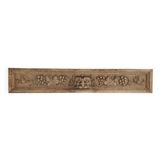 Natural wood pediment with bunches of grapes