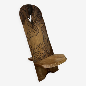 African chair with carved wooden palaver