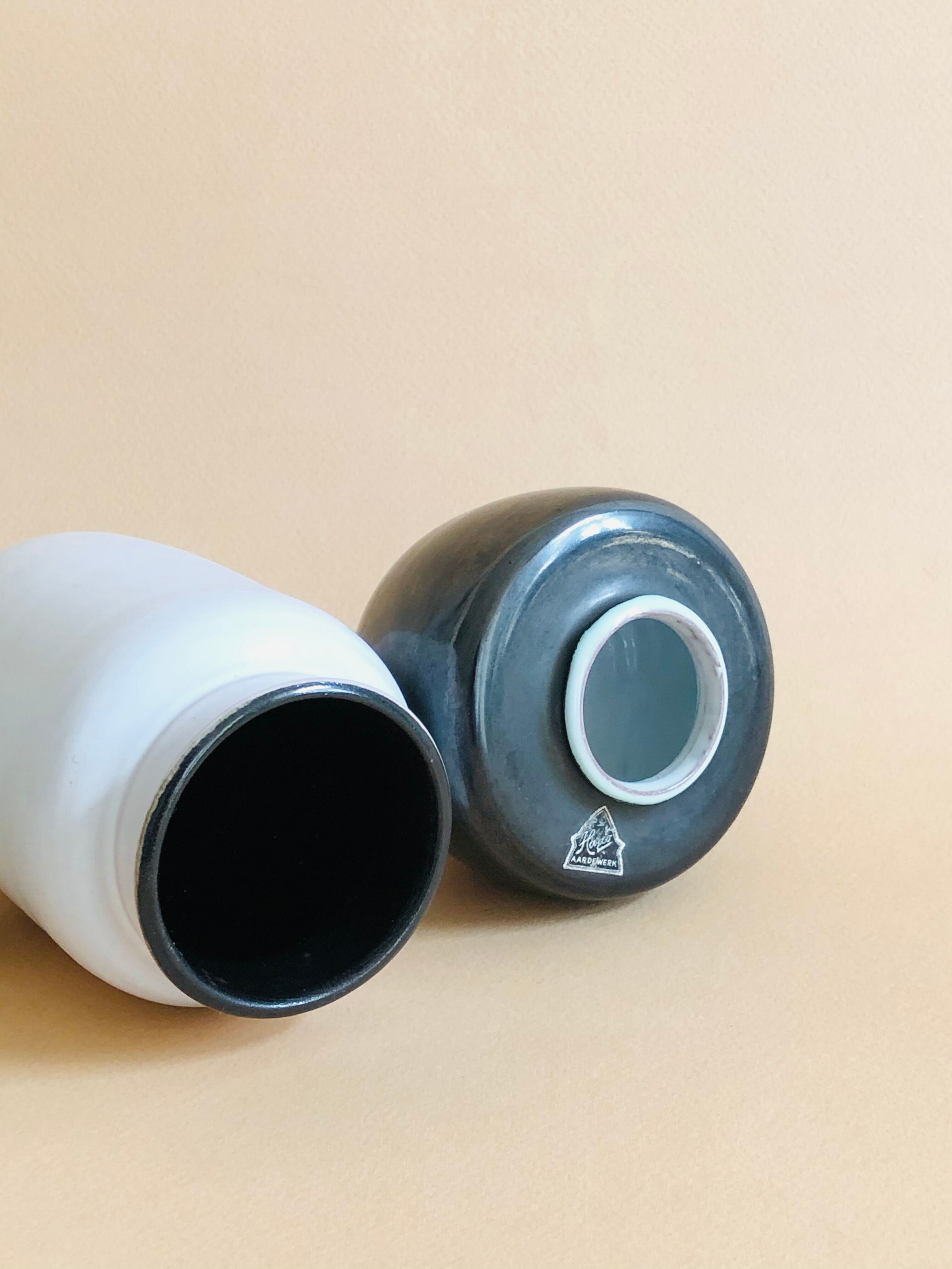 Duo of small black and white ceramic vases