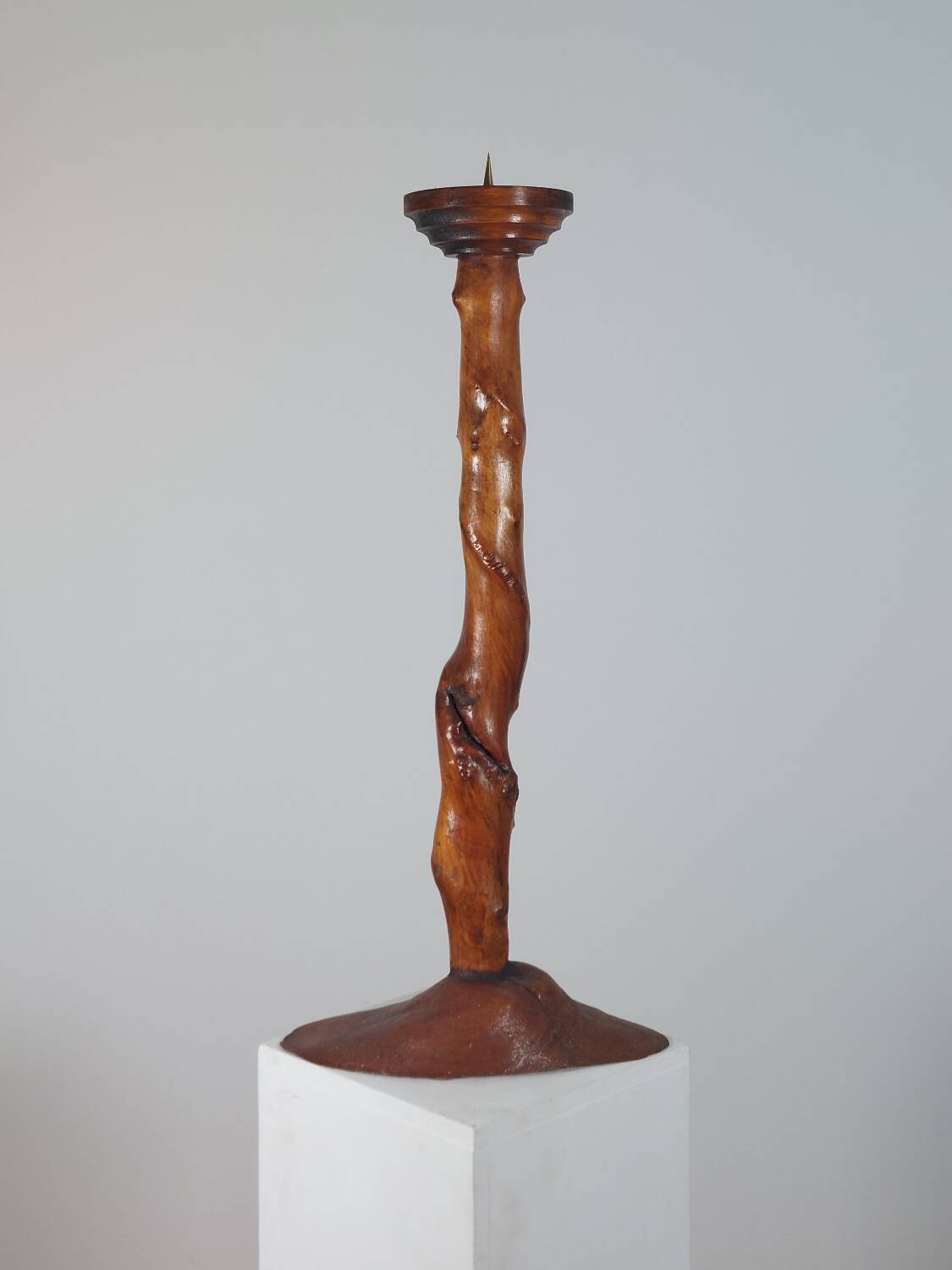 Vintage candle holder in an organic shape with a brass spike and tiered top.