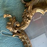 Antique scalloped mirror with pediment decorated with cherubs – carved gilded wood