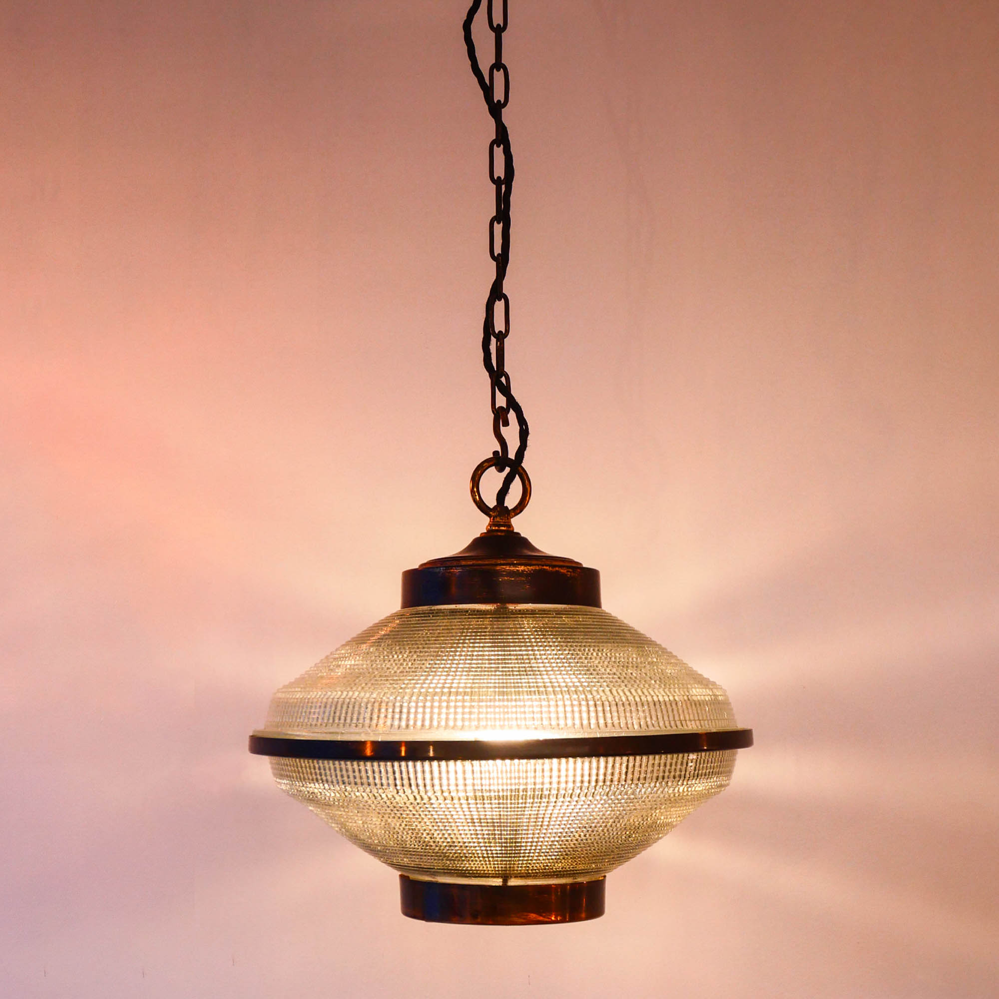 “Ellipse” pendant light in glass and patinated brass.