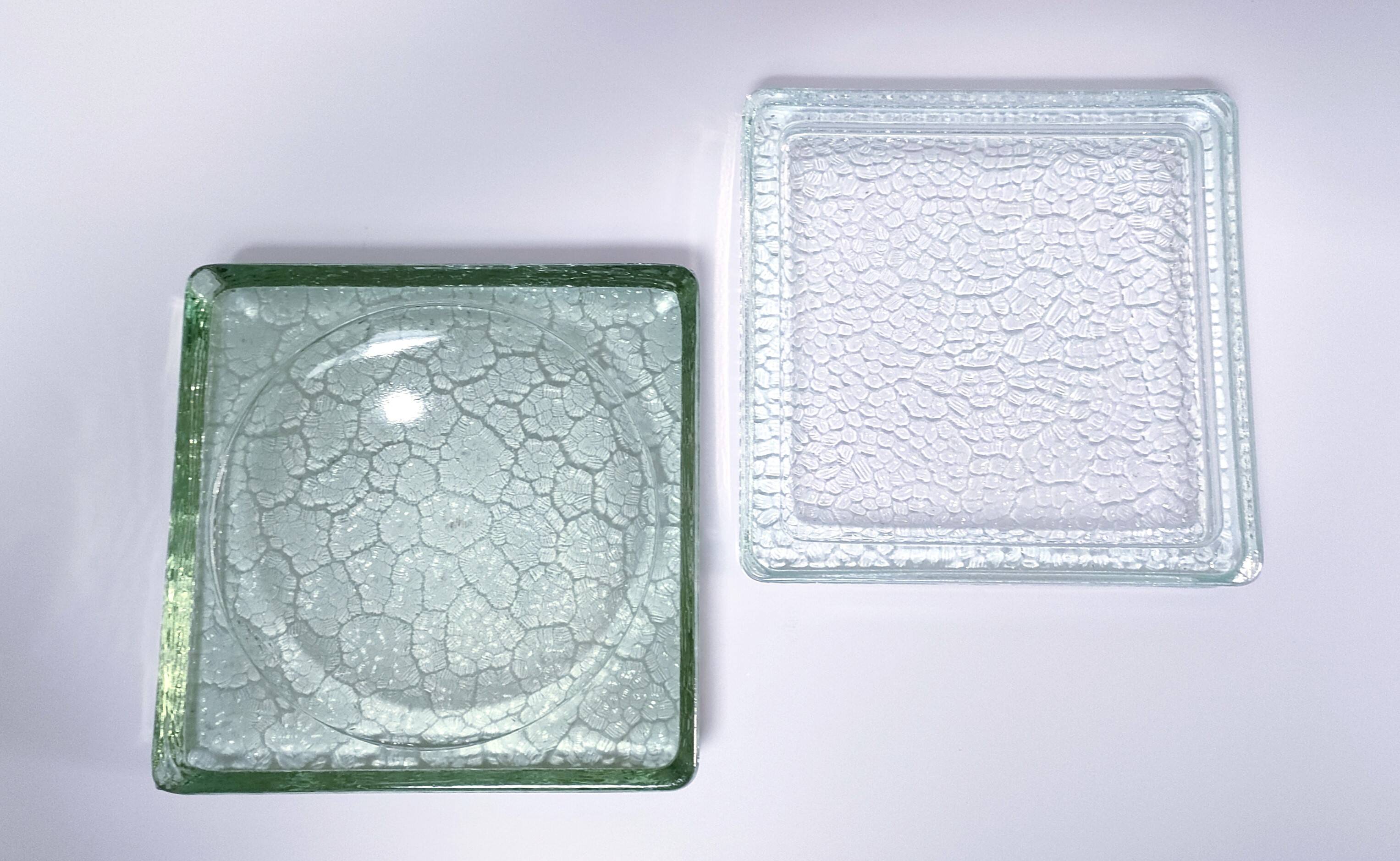 Two designer glass paving pockets