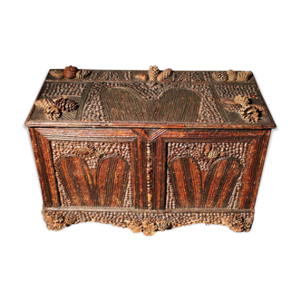 Furniture trunk in 19th tree covered with pine cones tree branches