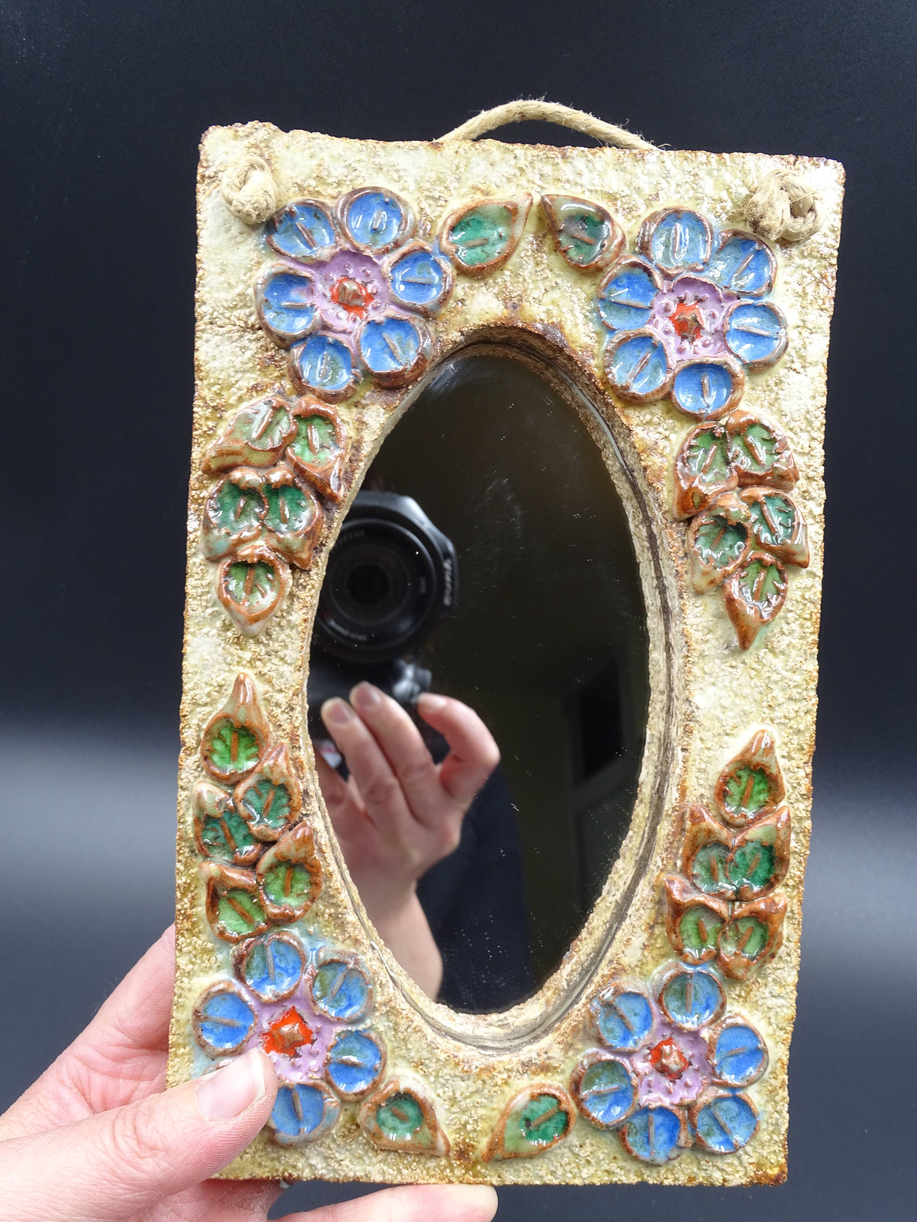 Flower-decorated sandstone mirror, circa 1970