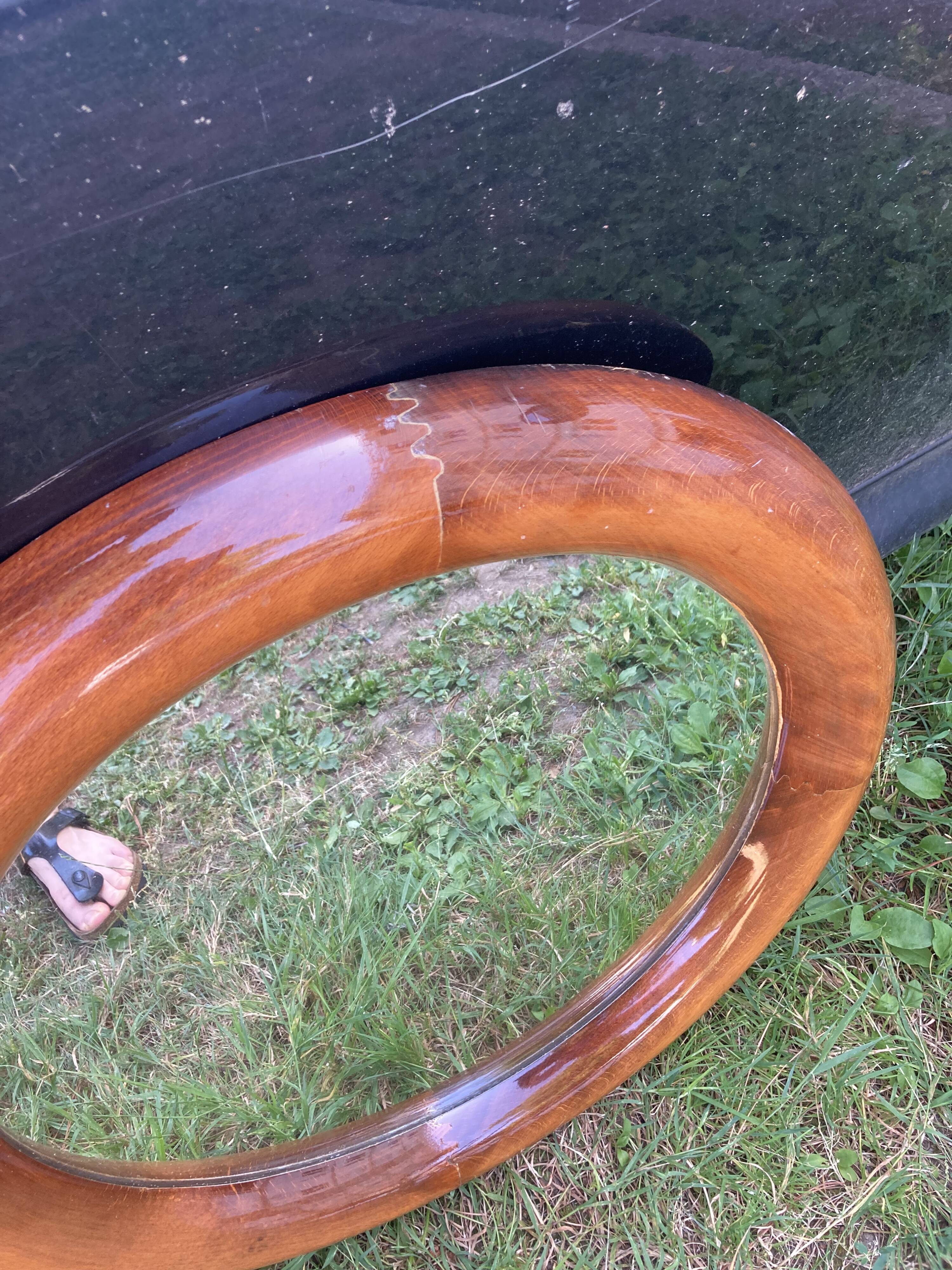 Round varnished wooden mirror