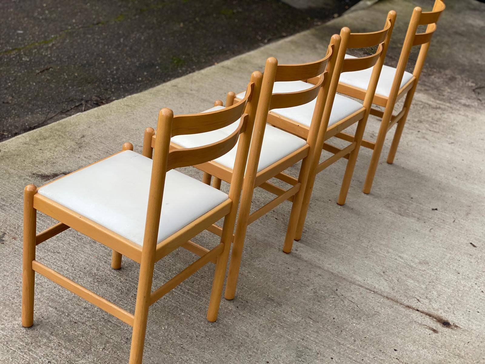 4 solid wood and white leather chairs