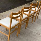 4 solid wood and white leather chairs