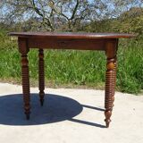 Antique walnut table with drop-leaf doors